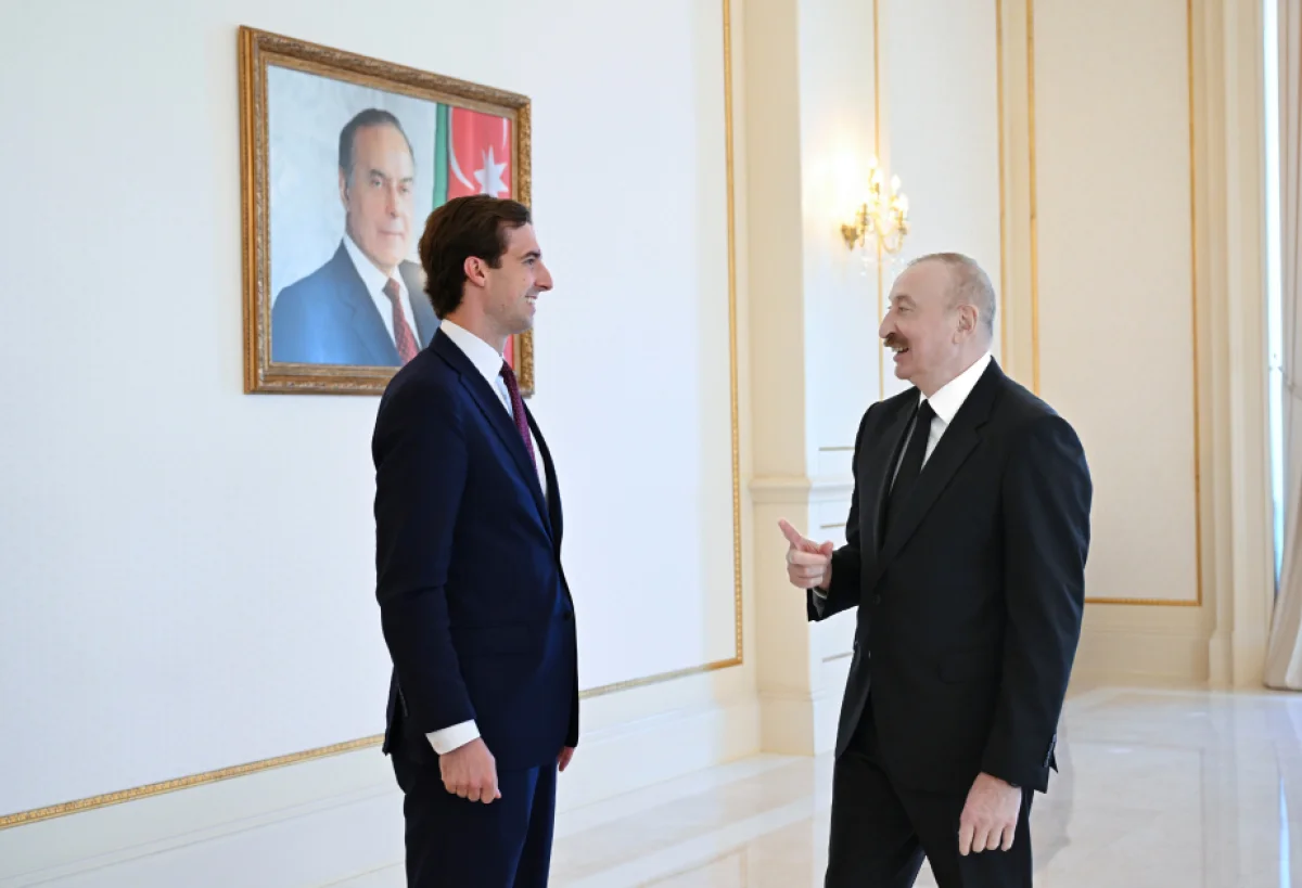 Prezident Kaleb Orra Tramp tərəfindən təqdim edilmiş xatirə hədiyyəsini göstərib